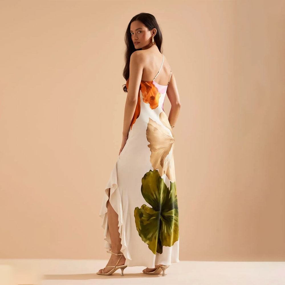 Elegante one shoulder maxi feestjurk met artistieke bloemenprint, golvende zoom en split.
