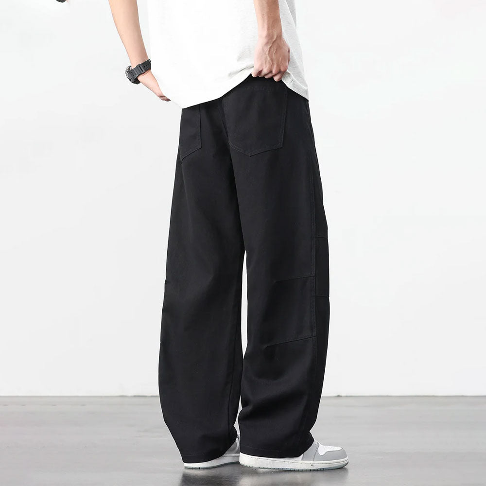 Zwarte retro katoenen workwear broek met losse pasvorm en zichtbare stiksels.