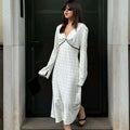Elegante witte satijnen maxi jurk met zwarte stippenprint, V-hals en kanten patchwork.