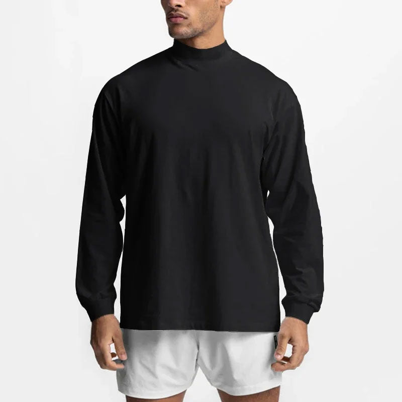 Zwart oversized sport-T-shirt met lange mouwen en colkraag, gemaakt van zachte katoenmix.